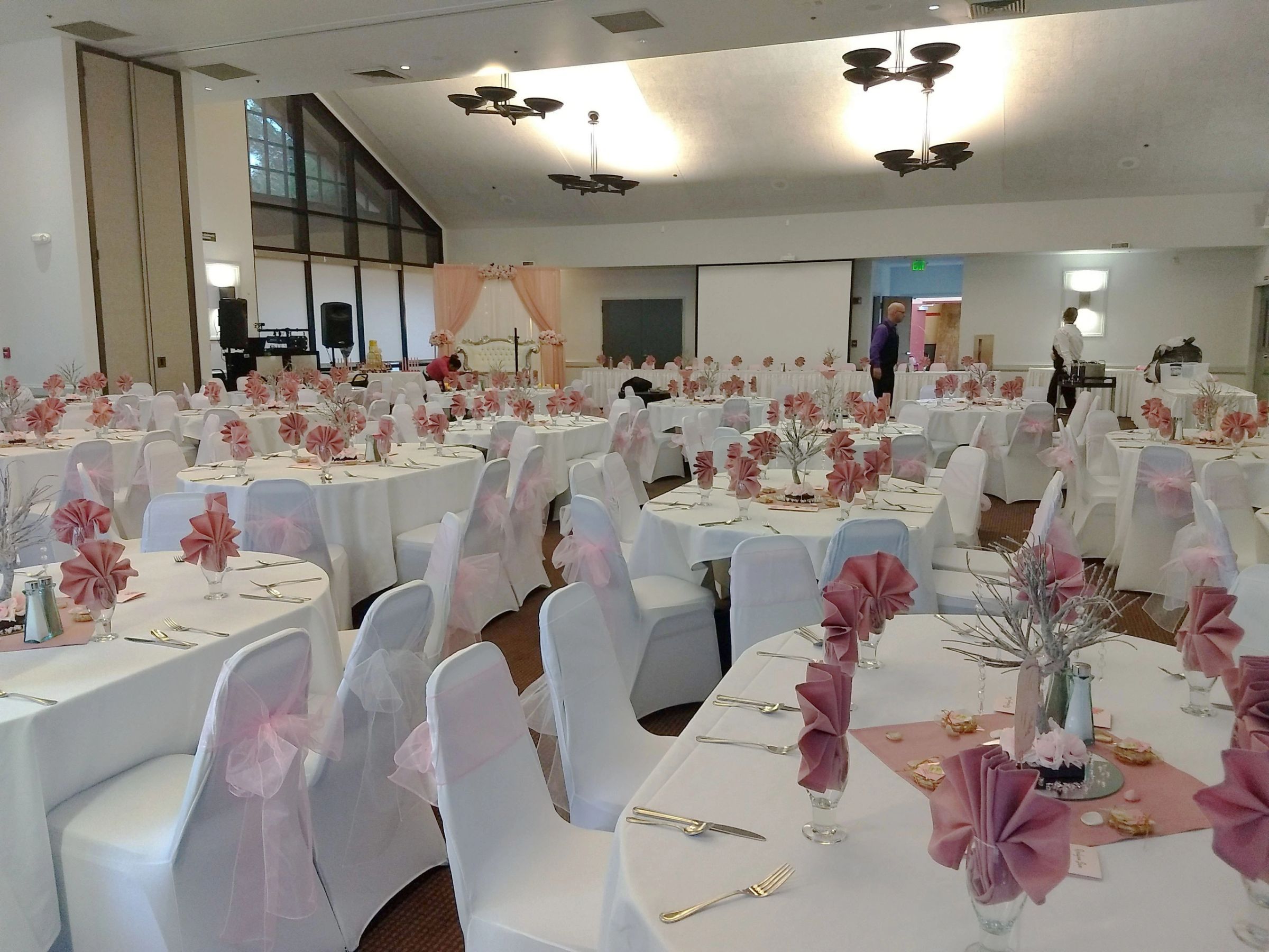 Full banquet room set in blush and white for a wedding reception