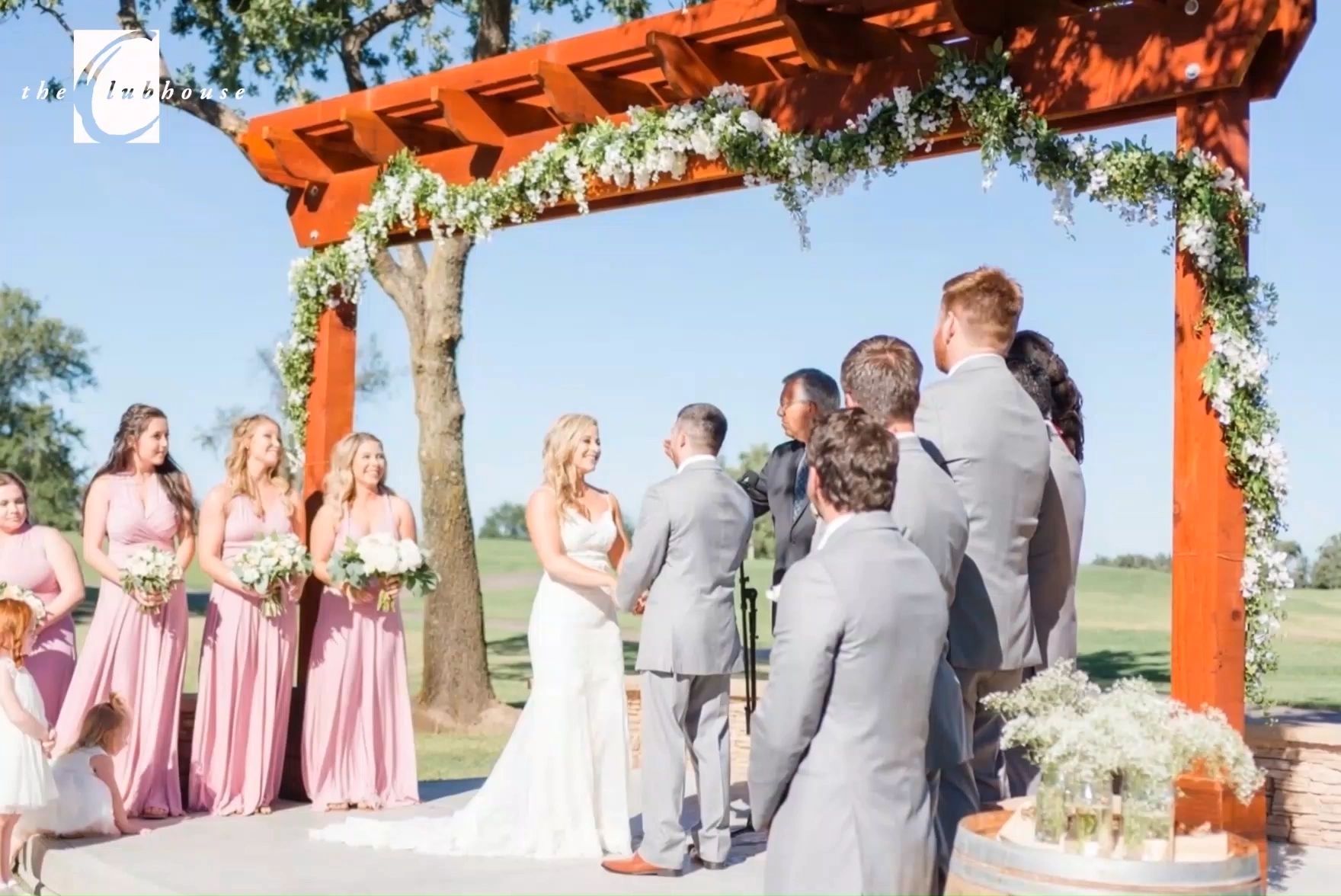 A wedding ceremony under the arbor at The Clubhouse at Woodcreek