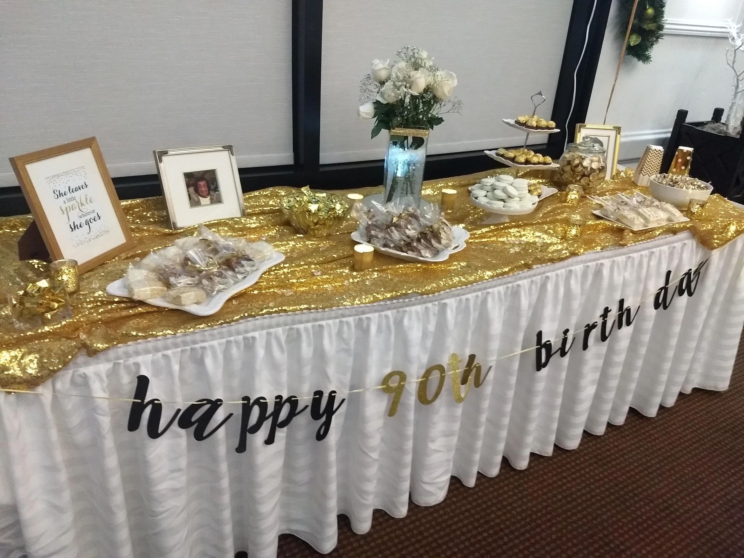 Milestone 90th birthday table with a gold sequin linen and dessert display