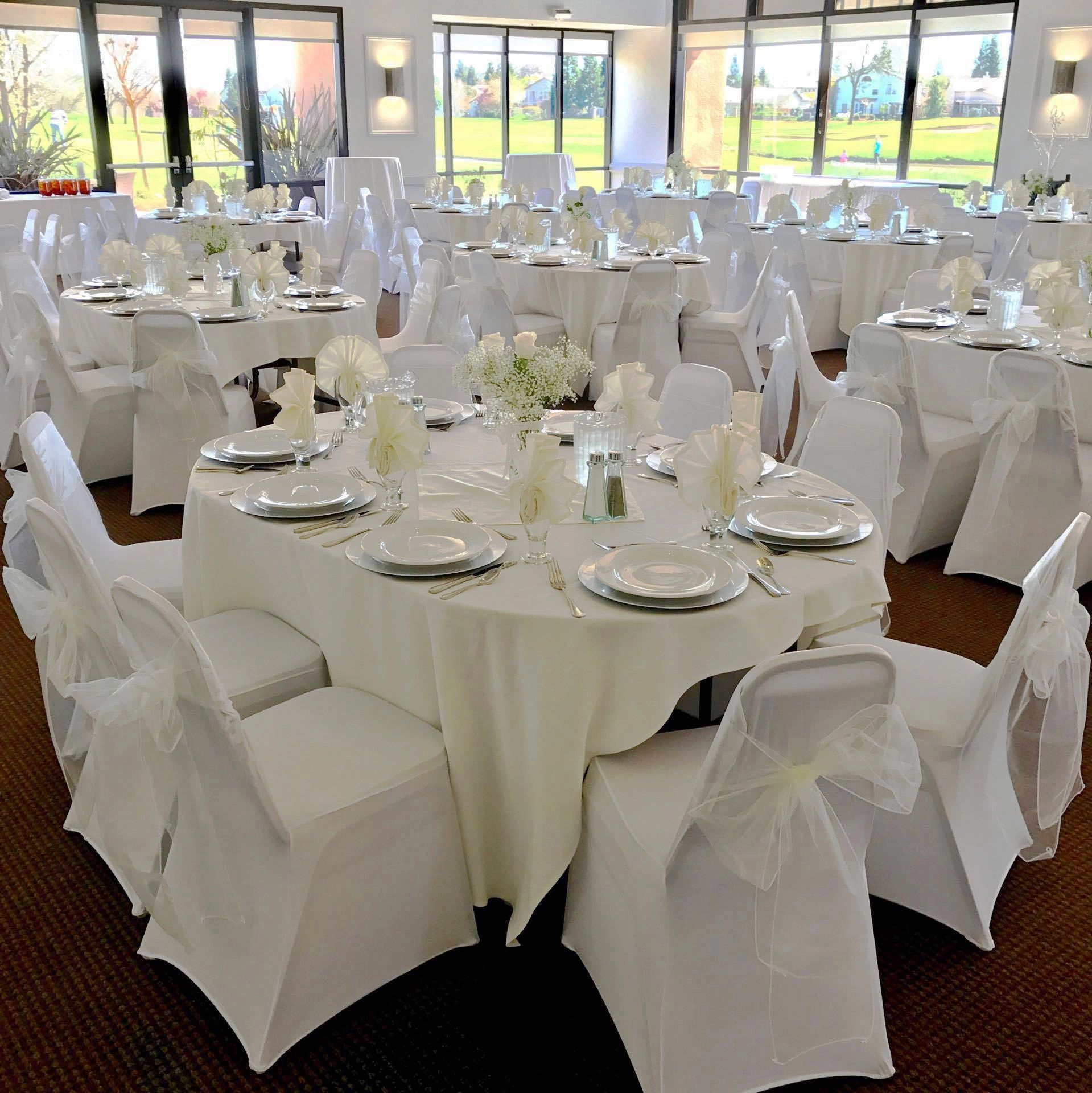 Banquet room set in classic white linens with chair covers